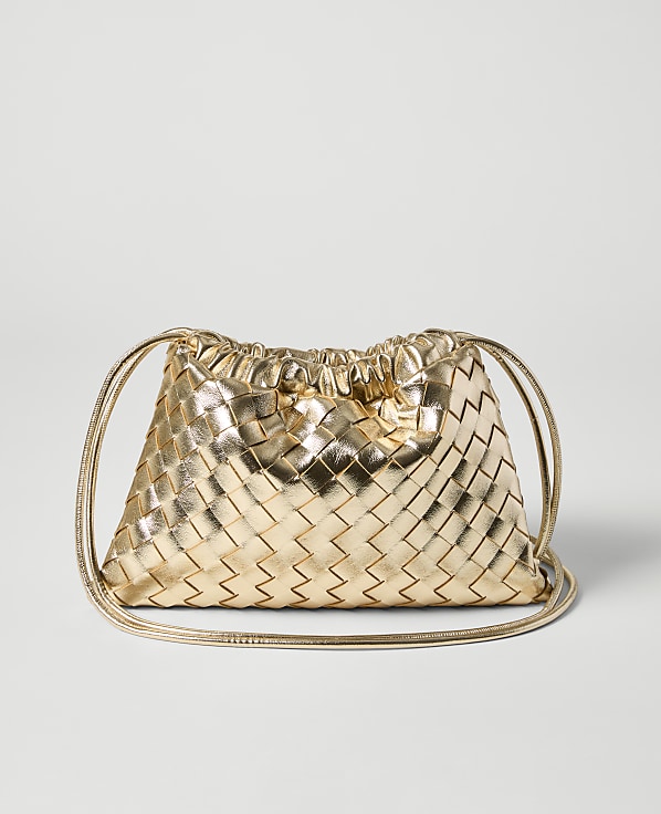 A metallic gold woven drawstring pouch bag rests on a plain light gray background.