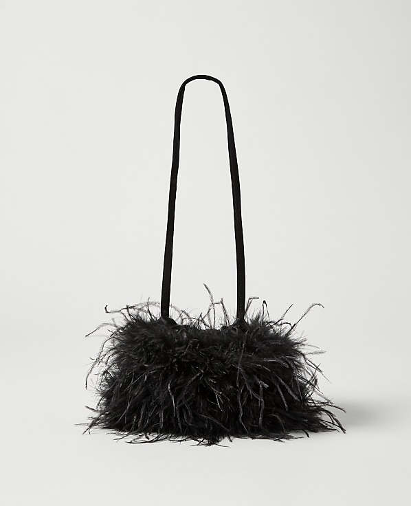 A black feathered handbag with thin straps rests against a plain white background.