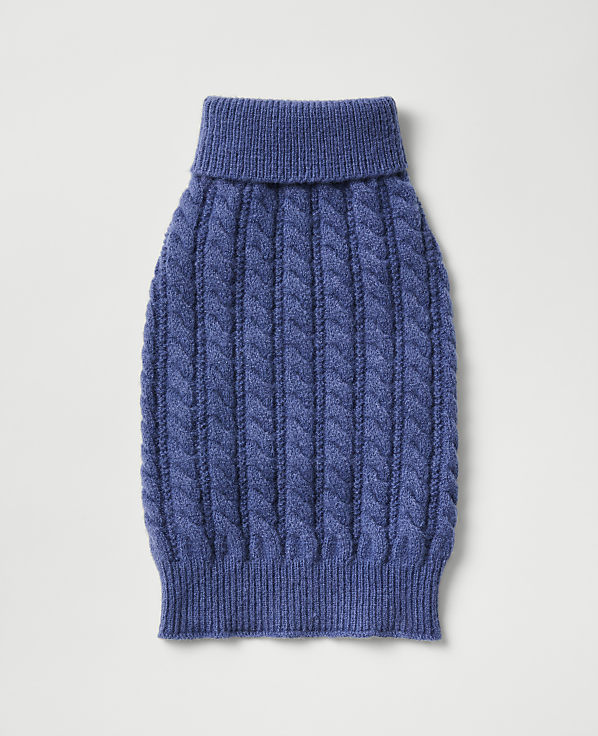 A blue cable-knit sweater for a pet is centered against a plain, light gray background.