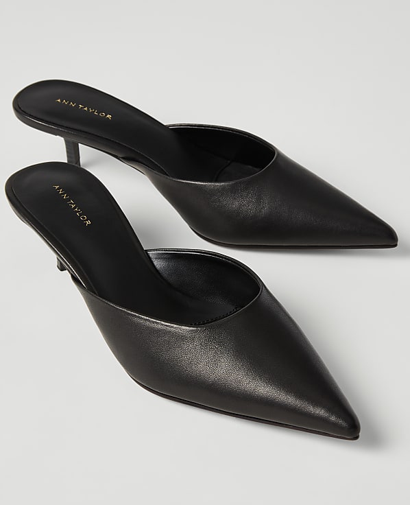 A pair of black pointed-toe Ann Taylor mule heels rests on a plain white background.