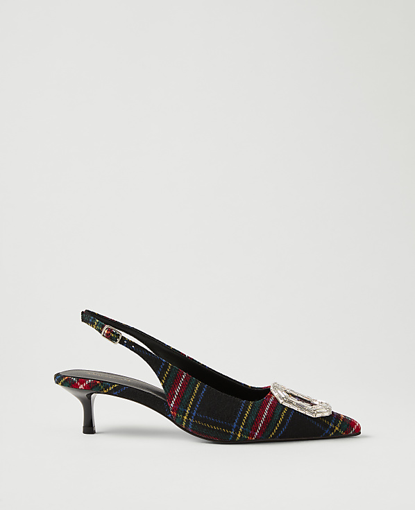 A plaid slingback heel with a crystal buckle sits against a plain, light gray background.