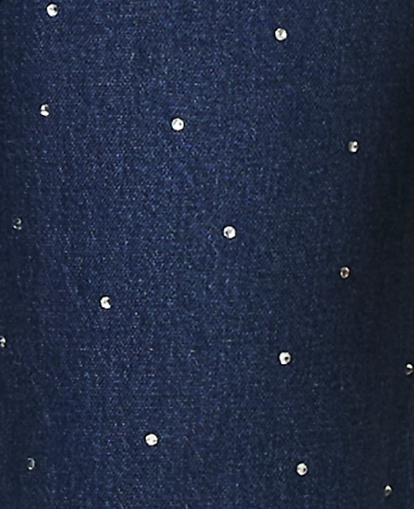 Small, sparkling rhinestones are scattered across a dark blue textured fabric background.