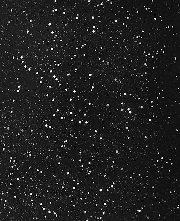 Numerous bright white dots of varying sizes are scattered across a solid black background.