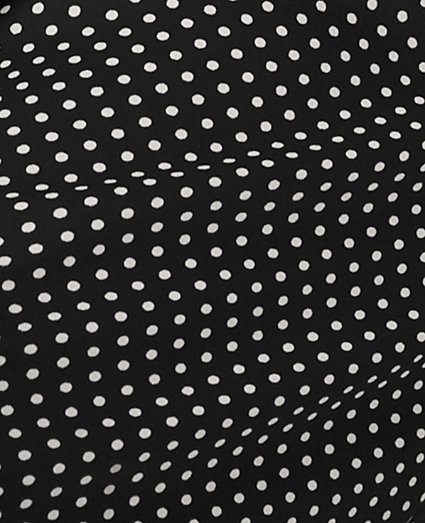 Small white polka dots are evenly spaced across a draped black fabric background.