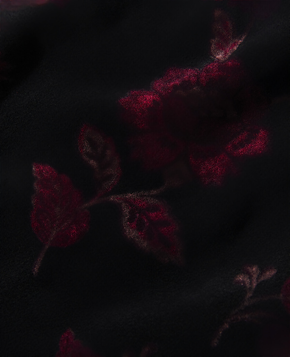 Dark red floral patterns are subtly embossed against a solid black background.