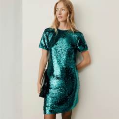Woman in a teal sequin shift dress