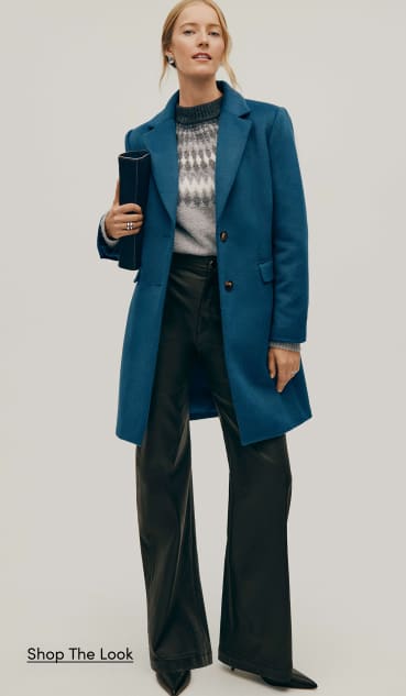 The Outerwear Shop — a woman in a blue coat, grey patterned sweater and black wide-leg trousers. Shop the Look.