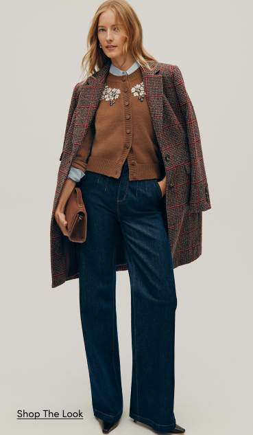 The Outerwear Shop — a woman in a brown cardigan, dark wash wide-leg jeans and a plaid topcoat. Shop the Look.