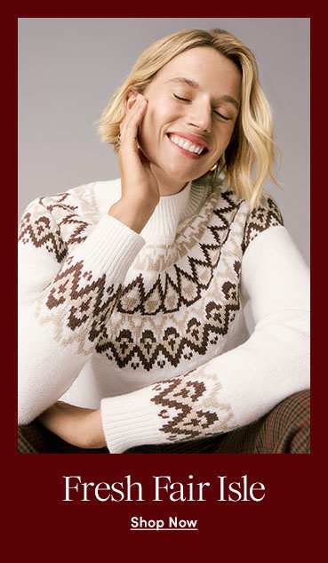 A smiling woman in a cream and brown Fair Isle sweater against a grey background.