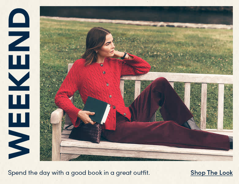 Spend the day with a good book in a great outfit — woman in a red cardigan reading by the water. Shop the Look.